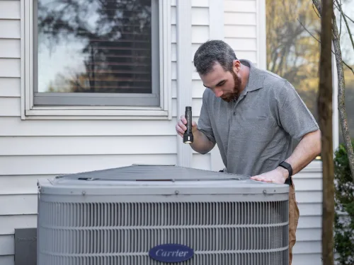 Technician inspecting an air conditioning system before a coil cleaning