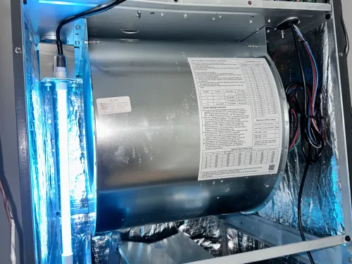 UV-C lamp mounted inside an air handler cabinet